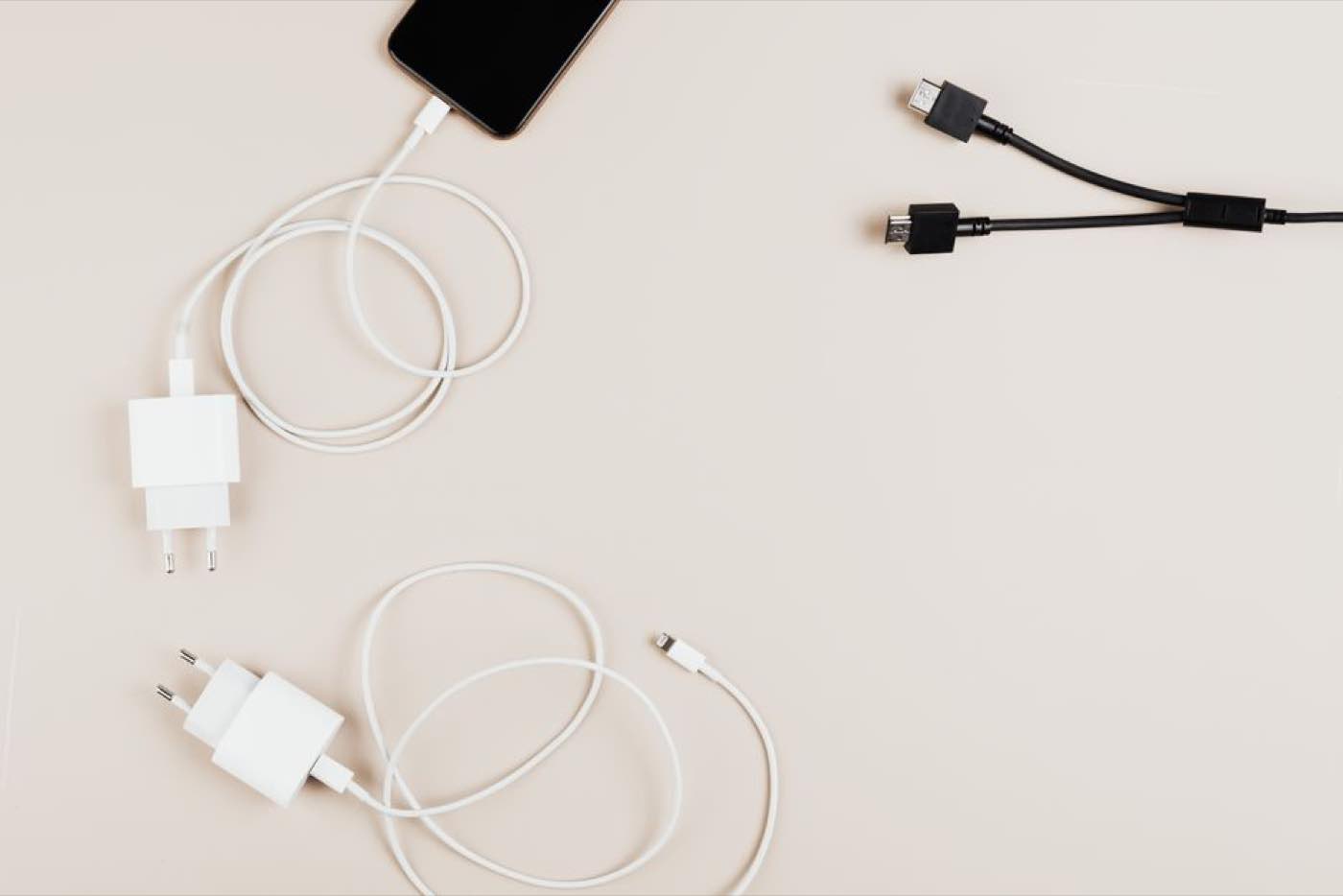 Chargers and cables laid out neatly on a pale background.